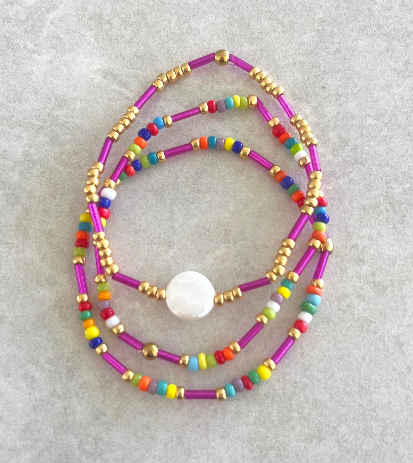 Trio de pulseras color fushia